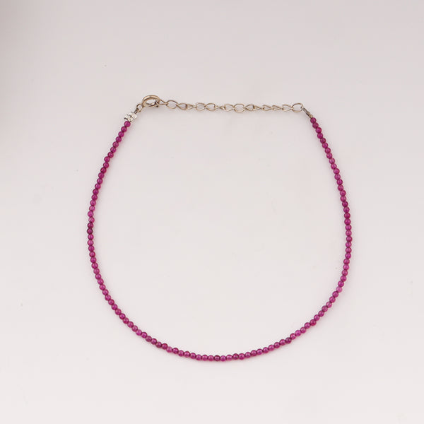 Close-up of pink ruby anklet chain