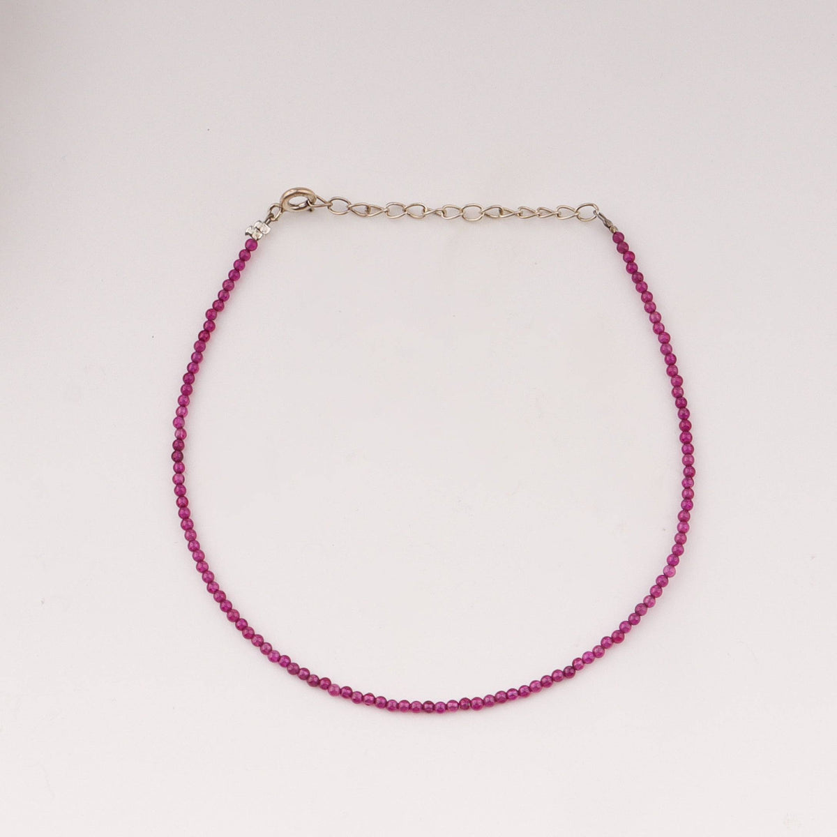Close-up of pink ruby anklet chain