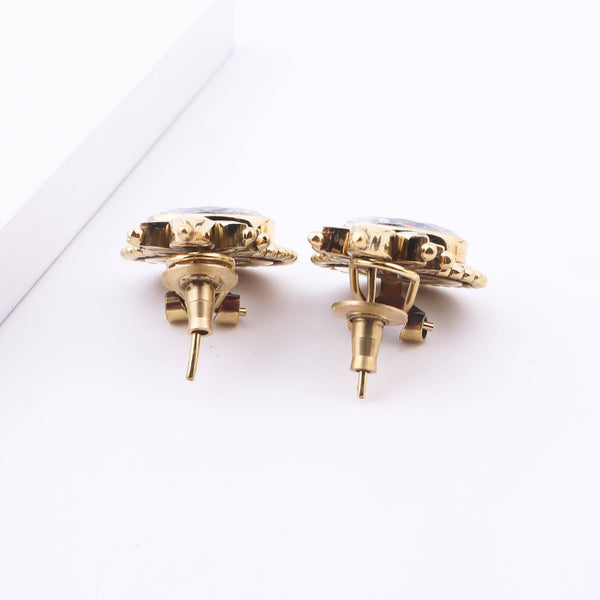Angled view of Brass Fashion Earrings highlighting the unique silhouette, structure, and polished brass finish