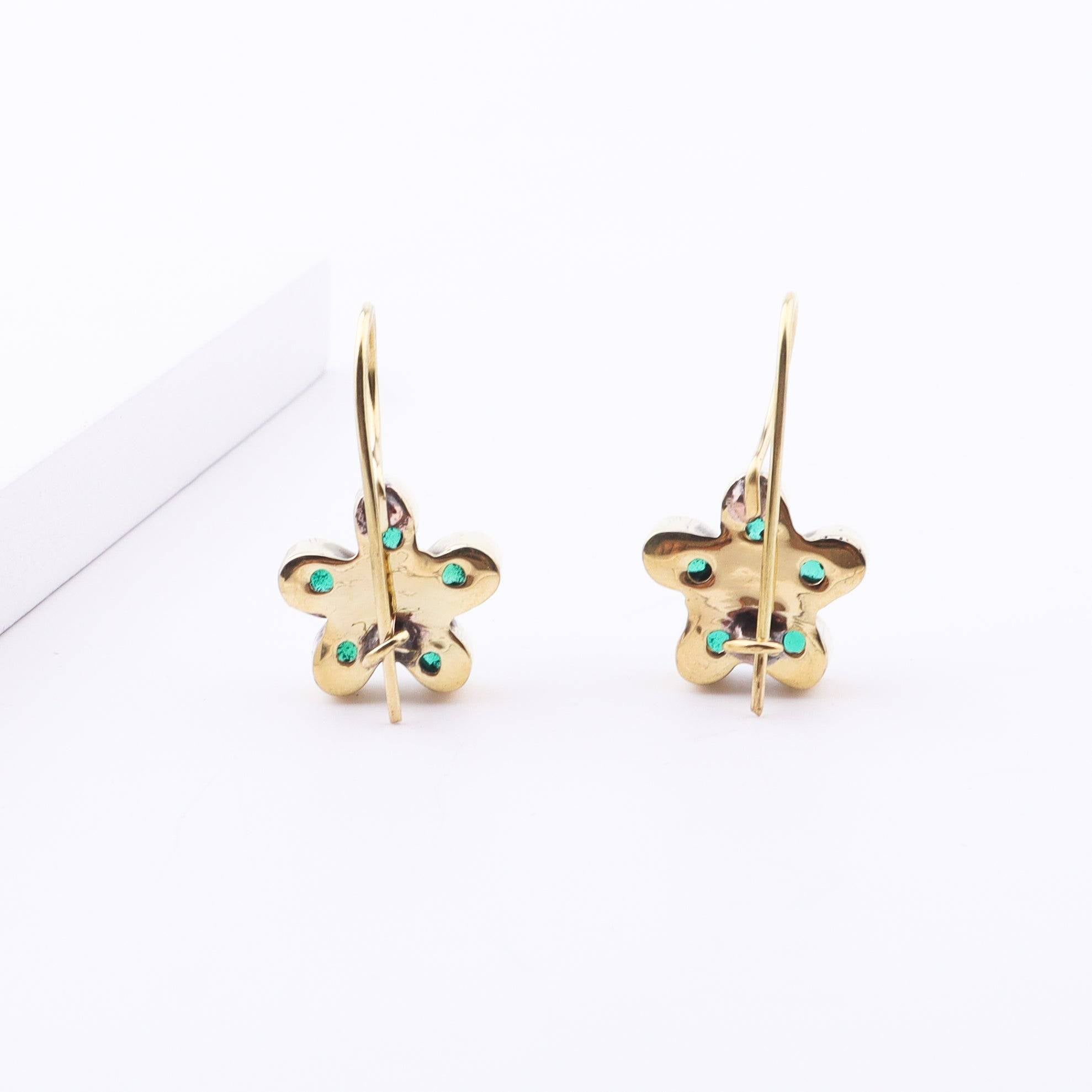 Angled view of Brass Fashion Earrings highlighting the unique silhouette, structure, and polished brass finish