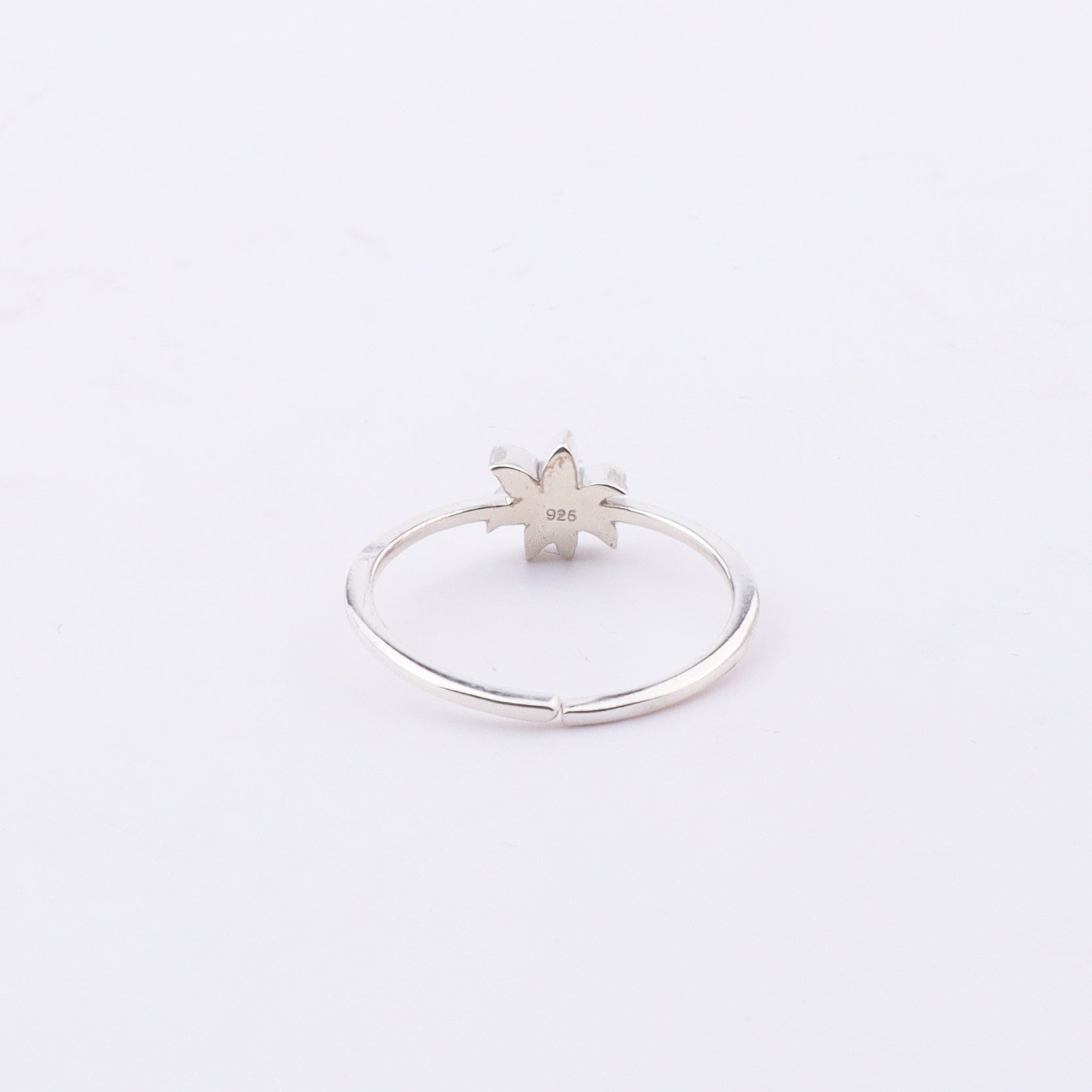 Close-up of Pink Lily enamel ring on finger