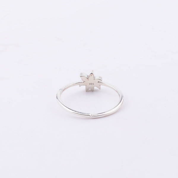 Close-up of Pink Lily enamel ring on finger