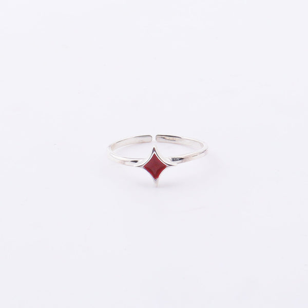 Close-up of Star Enamel Ring on finger, sterling silver with red enamel star