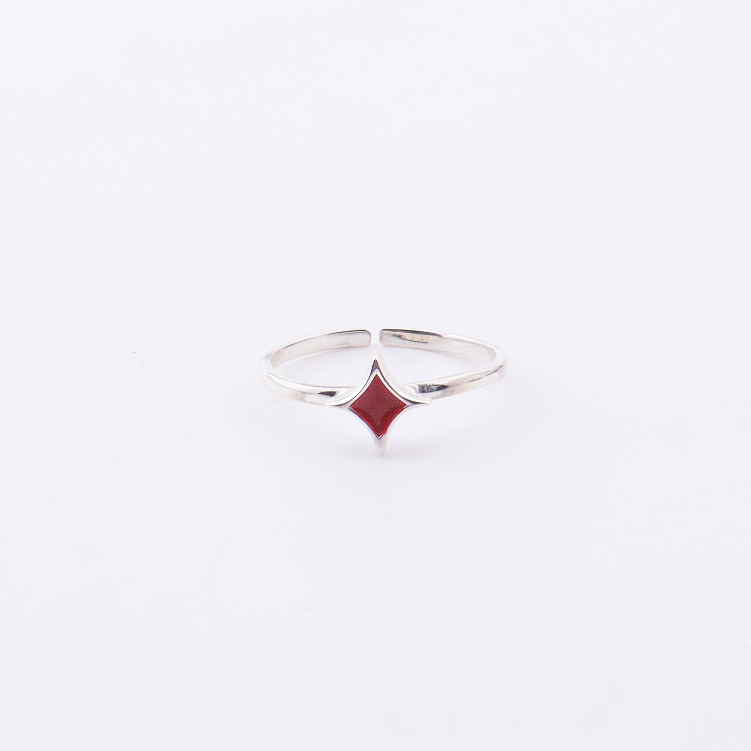 Close-up of Star Enamel Ring on finger, sterling silver with red enamel star