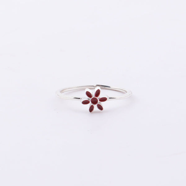 Sterling silver flower ring with red enamel on hand