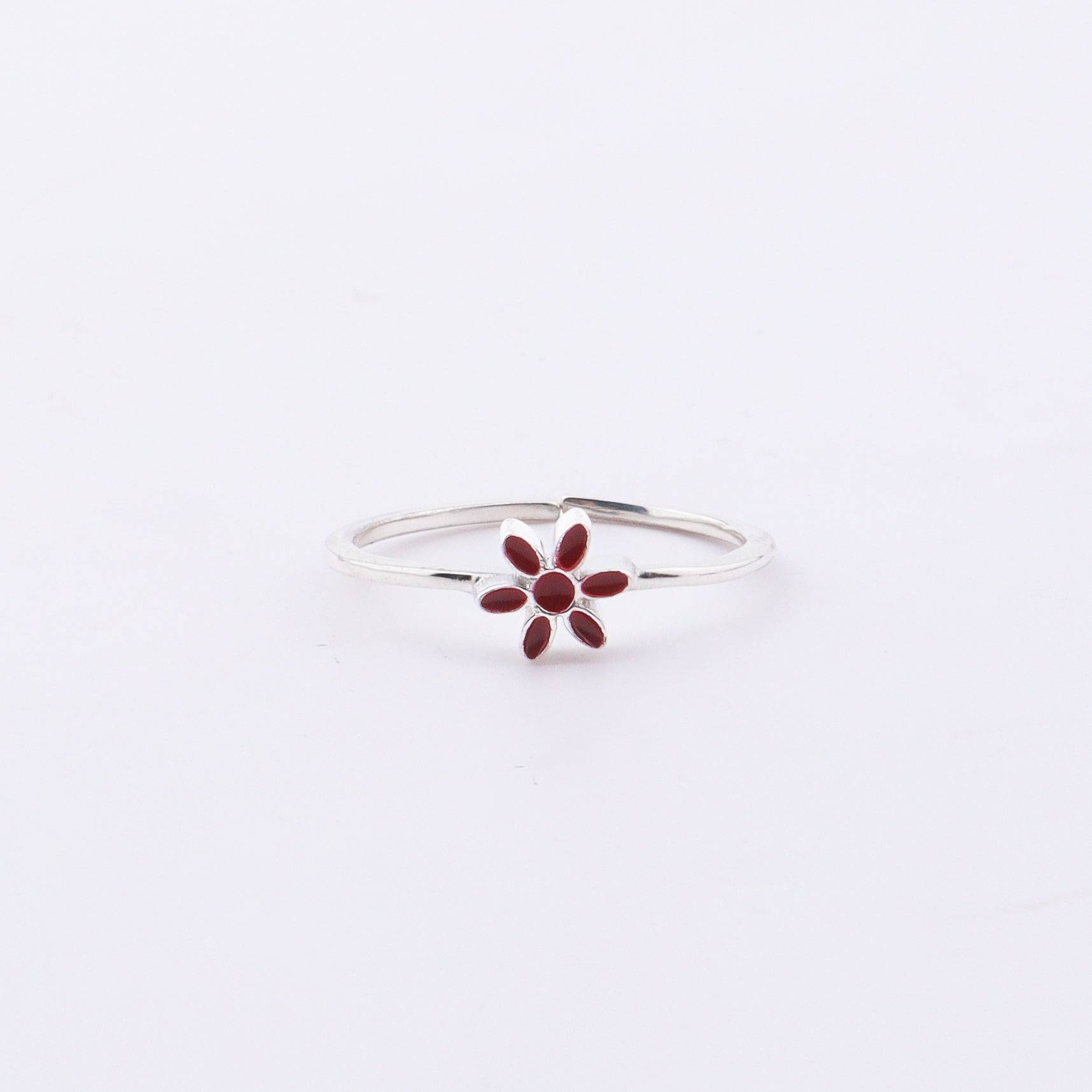 Sterling silver flower ring with red enamel on hand