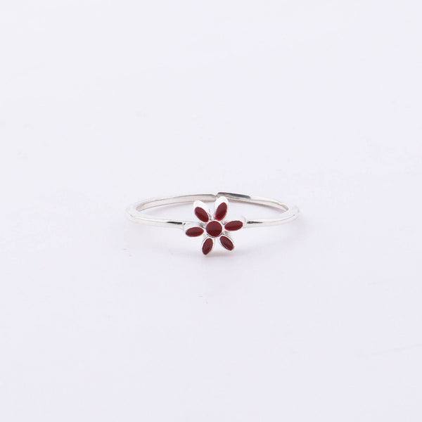 Sterling silver flower ring with red enamel on hand