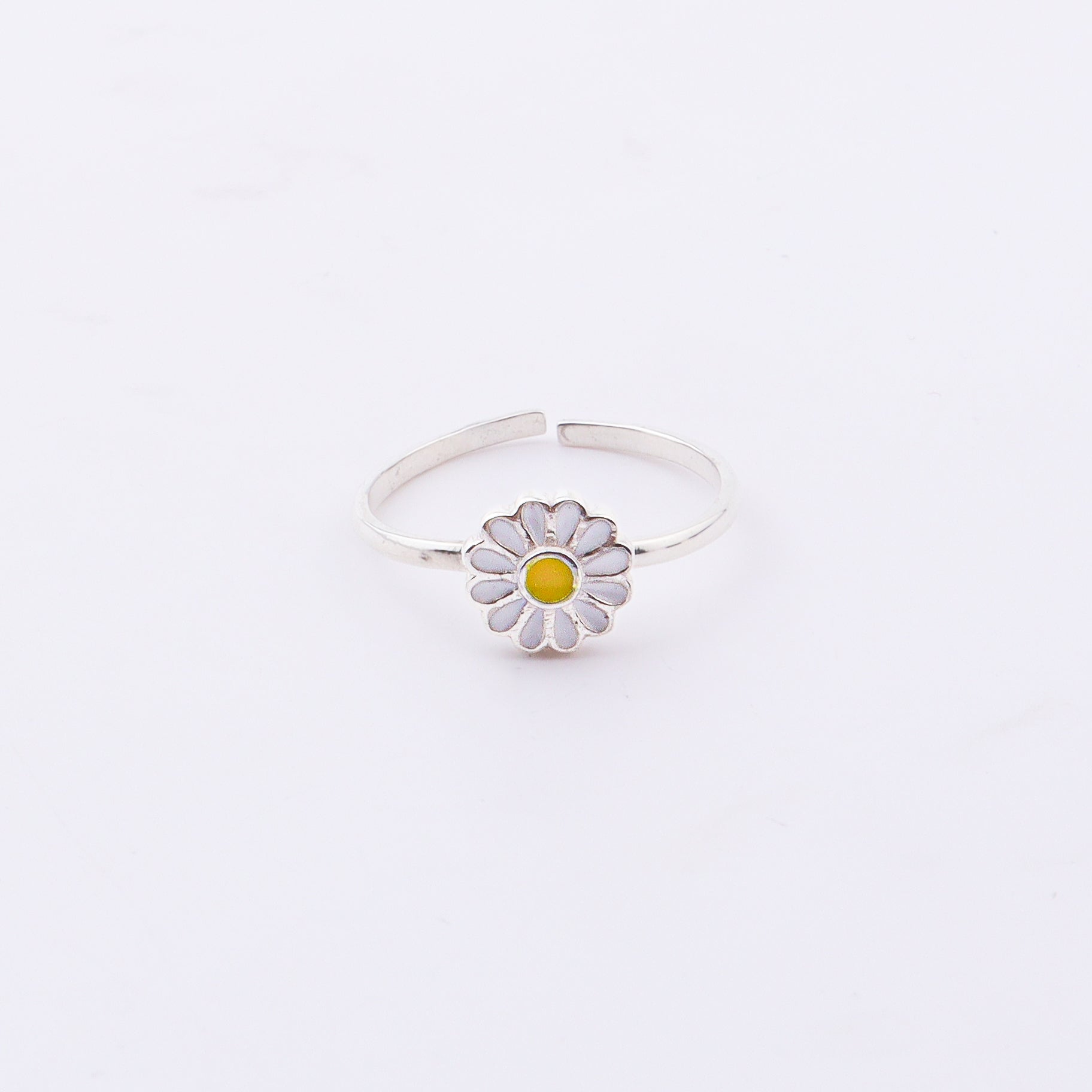Close-up of Daisy Flower Enamel Ring on hand