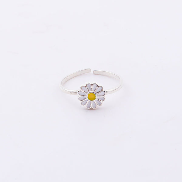 Close-up of Daisy Flower Enamel Ring on hand