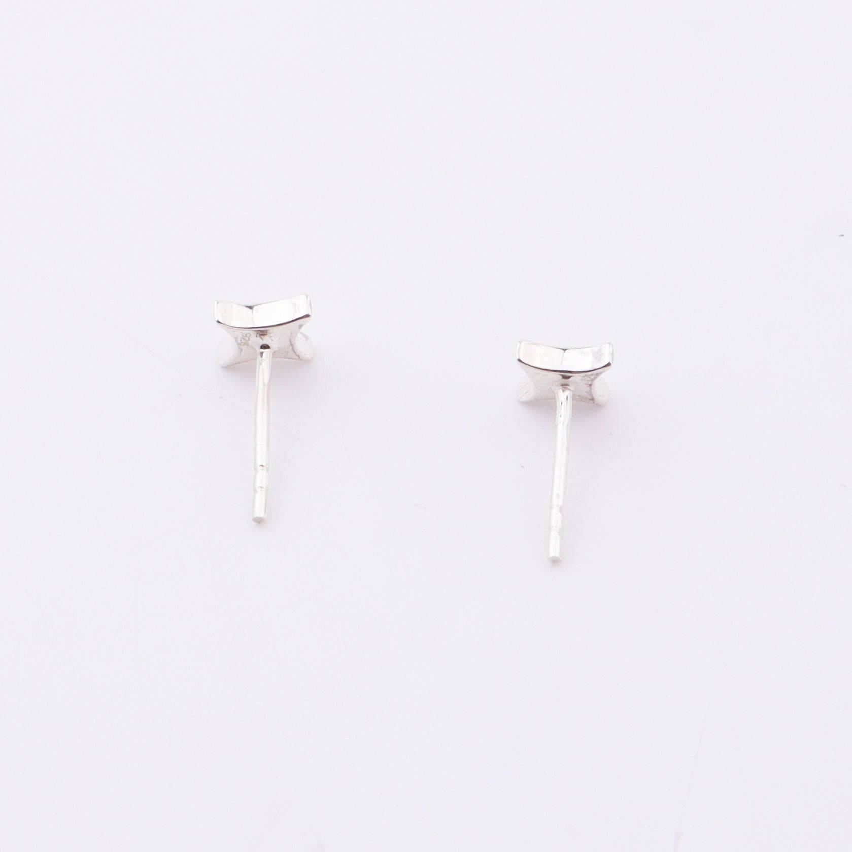 Sterling silver star enamel stud earrings on white background, jewelry detail