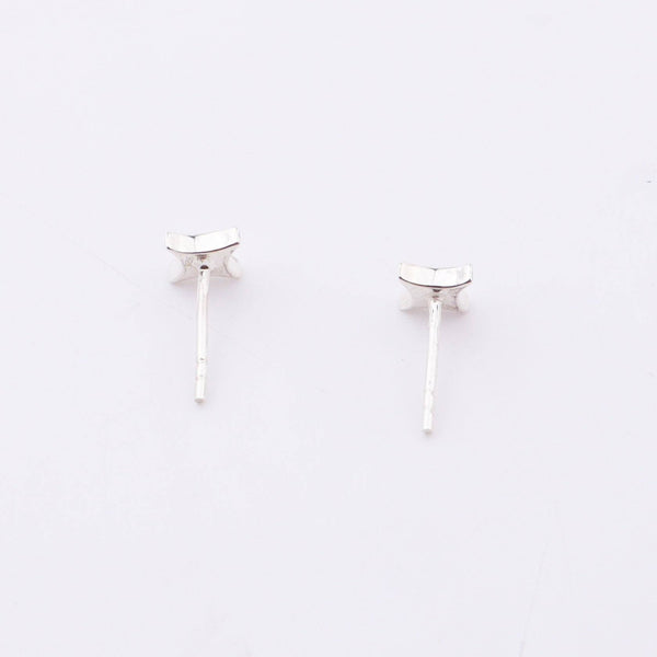 Sterling silver star enamel stud earrings on white background, jewelry detail