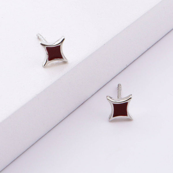 Close-up of star enamel stud earrings in sterling silver, jewelry display