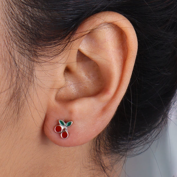 Model wearing cherry enamel earrings with black hair