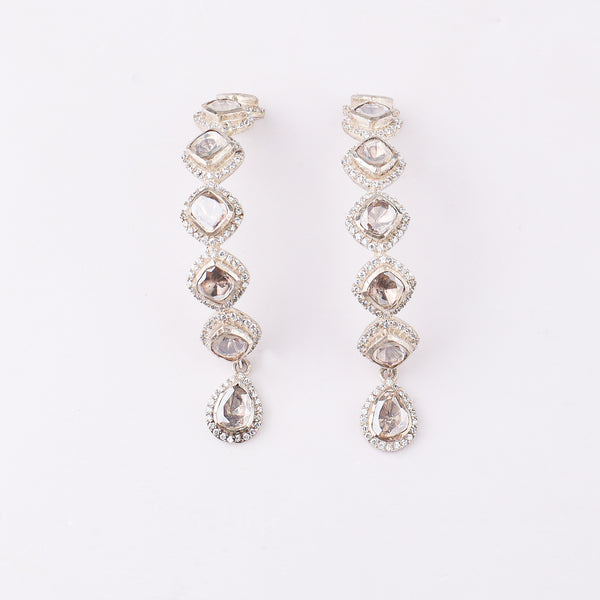 Fashion jewelry with moissanite stones on white surface