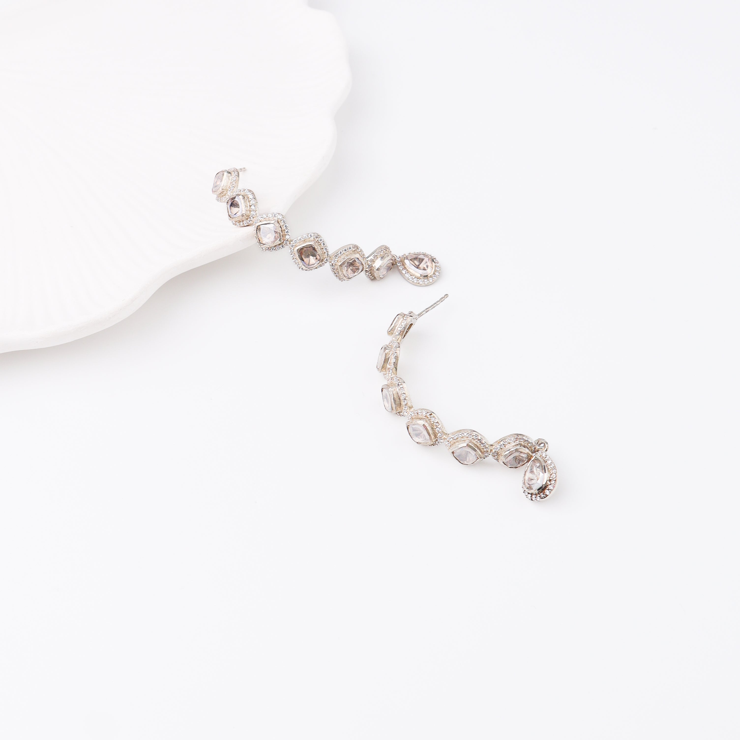 White background showcasing sparkling moissanite earrings