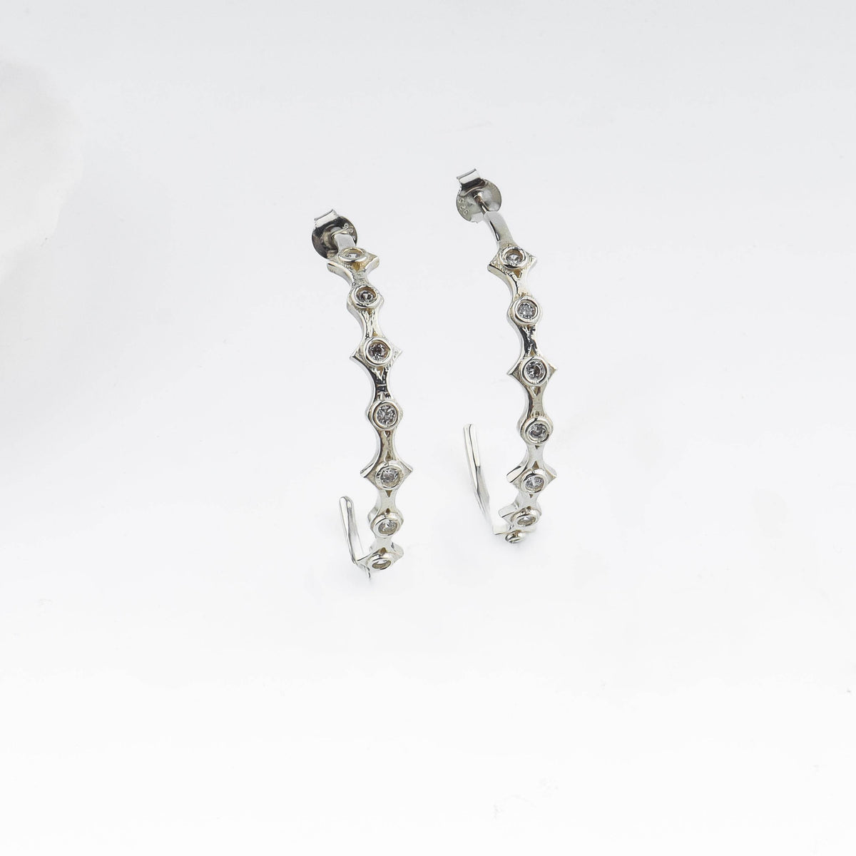 Silver diamond-shaped hoop earrings with CZ stones