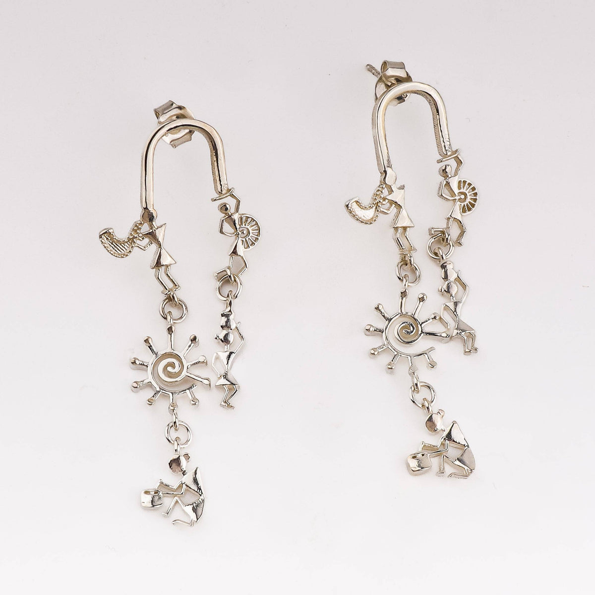 Silver earrings with Warli motifs and dangling sun and dancer charms