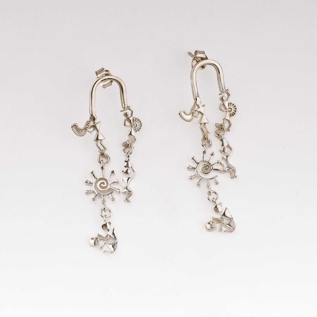 Silver earrings with Warli motifs and artisanal design