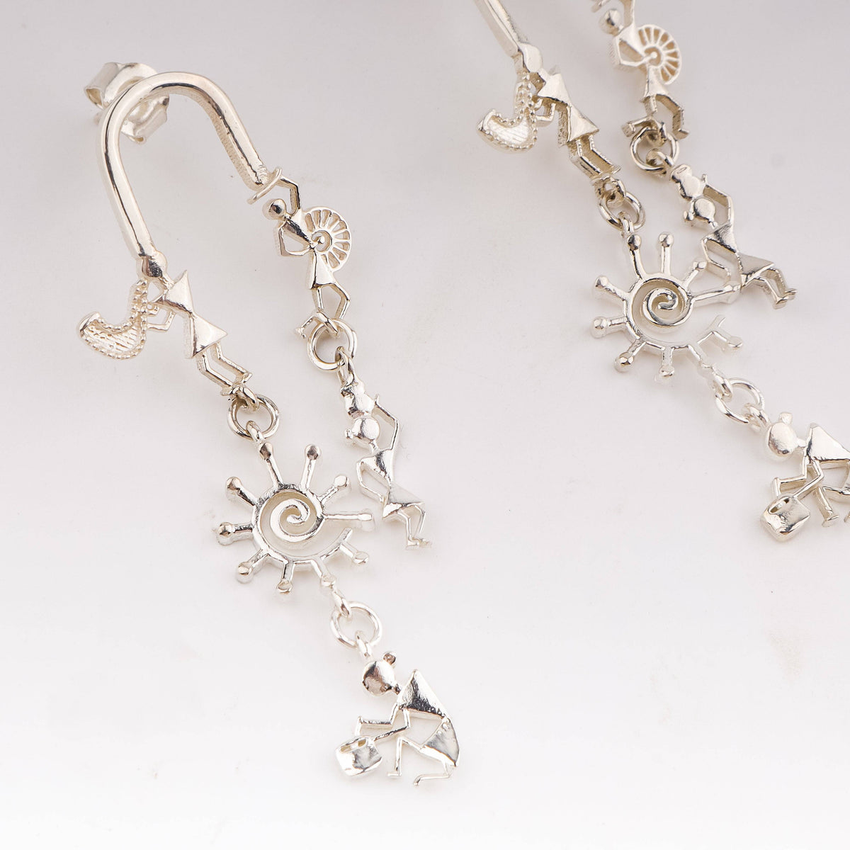 Silver earrings with Warli motifs and dance designs