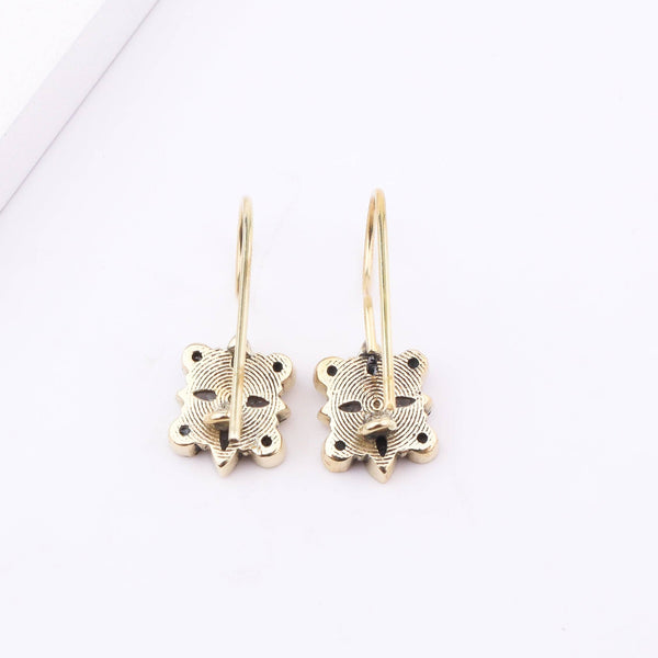 Angled view of Brass Fashion Earrings highlighting the unique silhouette, structure, and polished brass finish