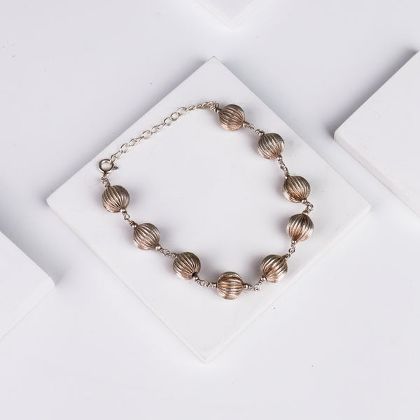 Close-up of silver beaded bracelet