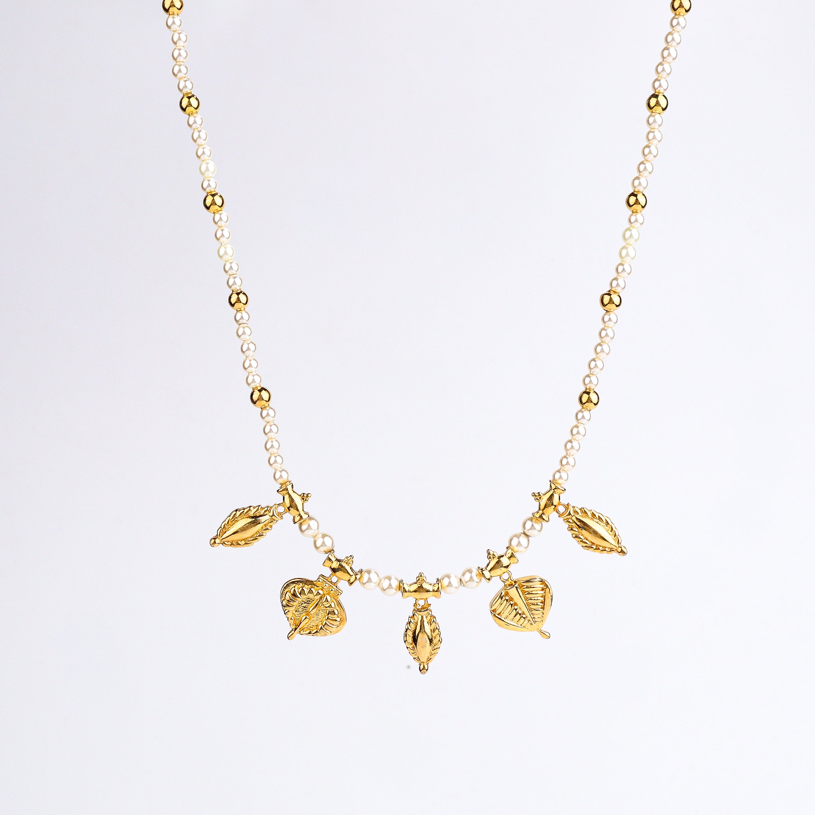 Gold plated pearl necklace styled with saree and traditional outfit