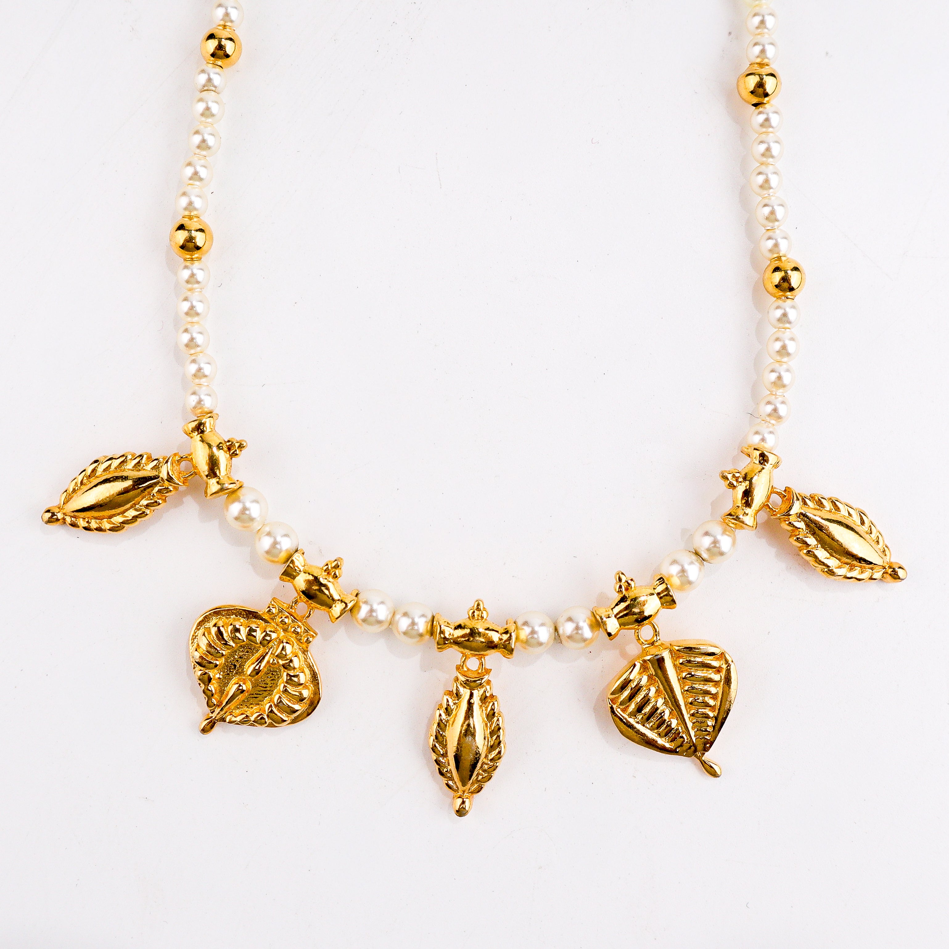 wear pearl necklace with leaf and badam motif for festive styling