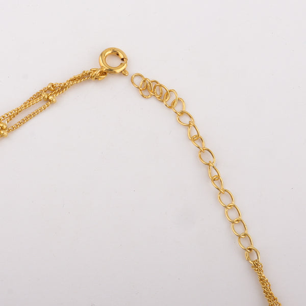 Close-up of gold chain necklace clasp