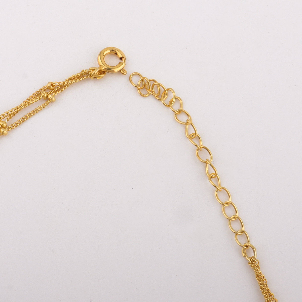 Close-up of gold chain necklace clasp