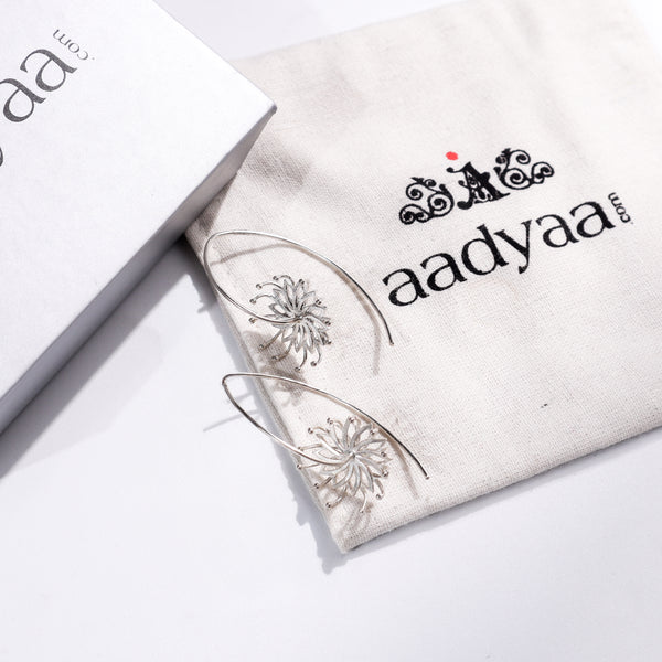 Sterling silver flower earrings with intricate design on Aadyaa jewelry pouch