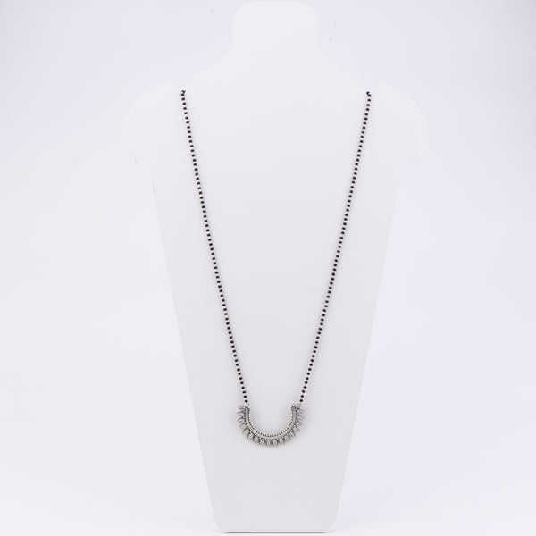 Mannequin displaying silver filigree mangalsutra necklace