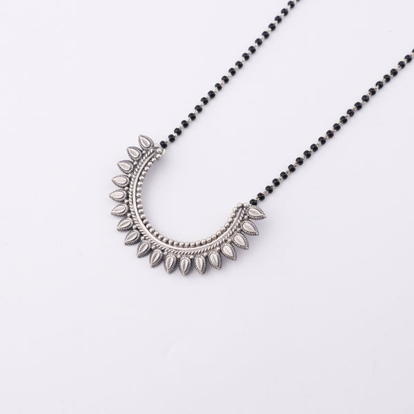 Close-up of silver mangalsutra chain with pendant