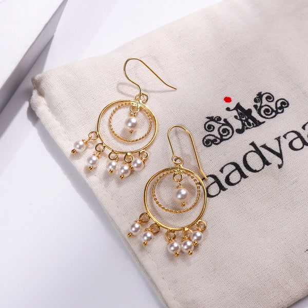 Gold plated pearl chandelier earrings with dangling pearls and circular design