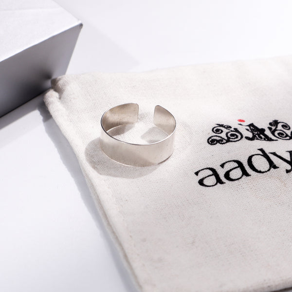 Unisex silver ring on Aadyaa jewelry pouch