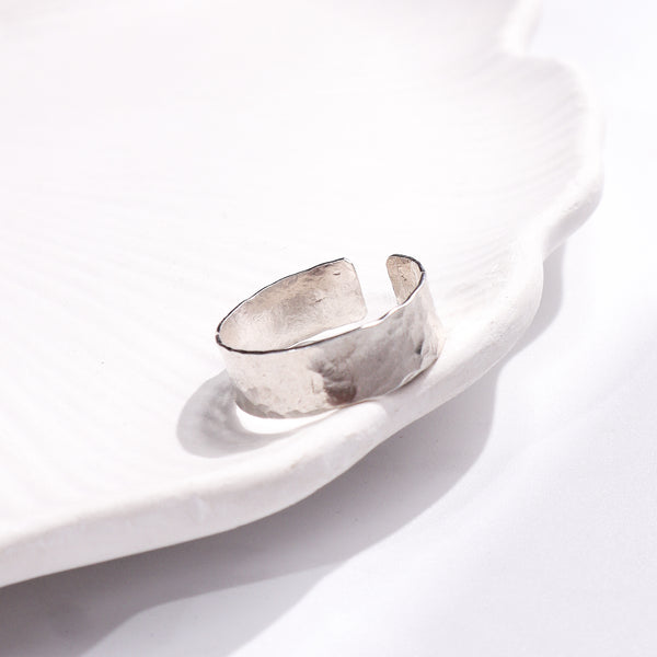 Unisex Hammered Ring on white ceramic dish