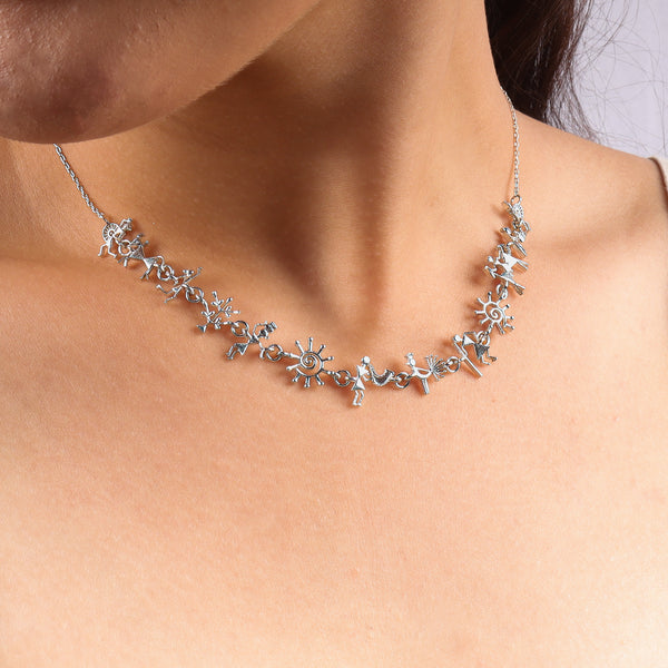 Silver necklace with Warli tribal motifs on a model