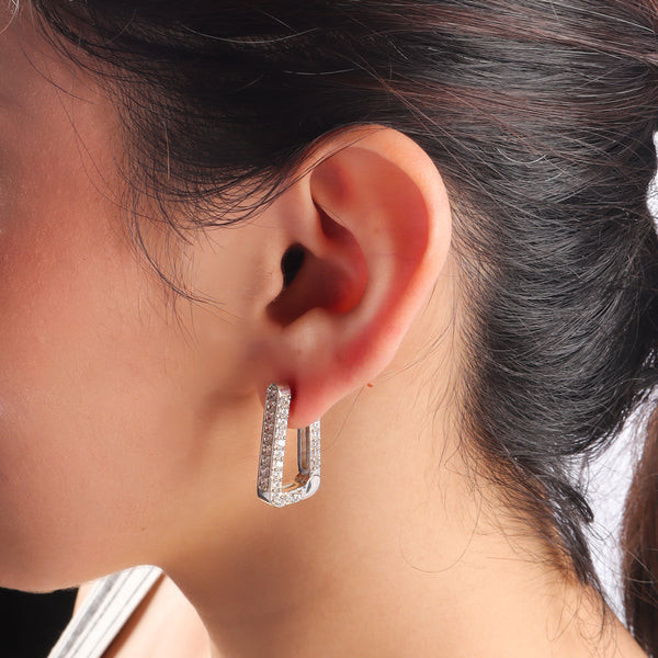 Silver CZ stone earrings worn by model