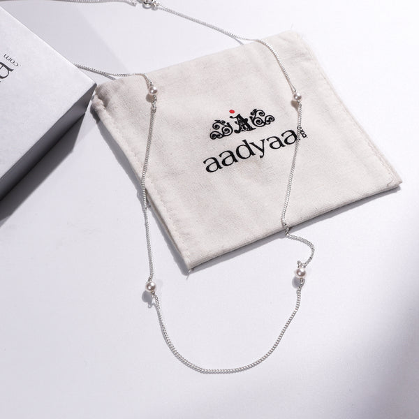 Elegant pearl silver necklace with white pearls on a white background