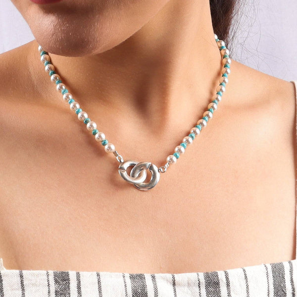 Pearl and turquoise beaded necklace with infinity lock clasp on model
