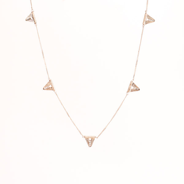 Detail shot highlighting polished silver spiral and geometric edges
