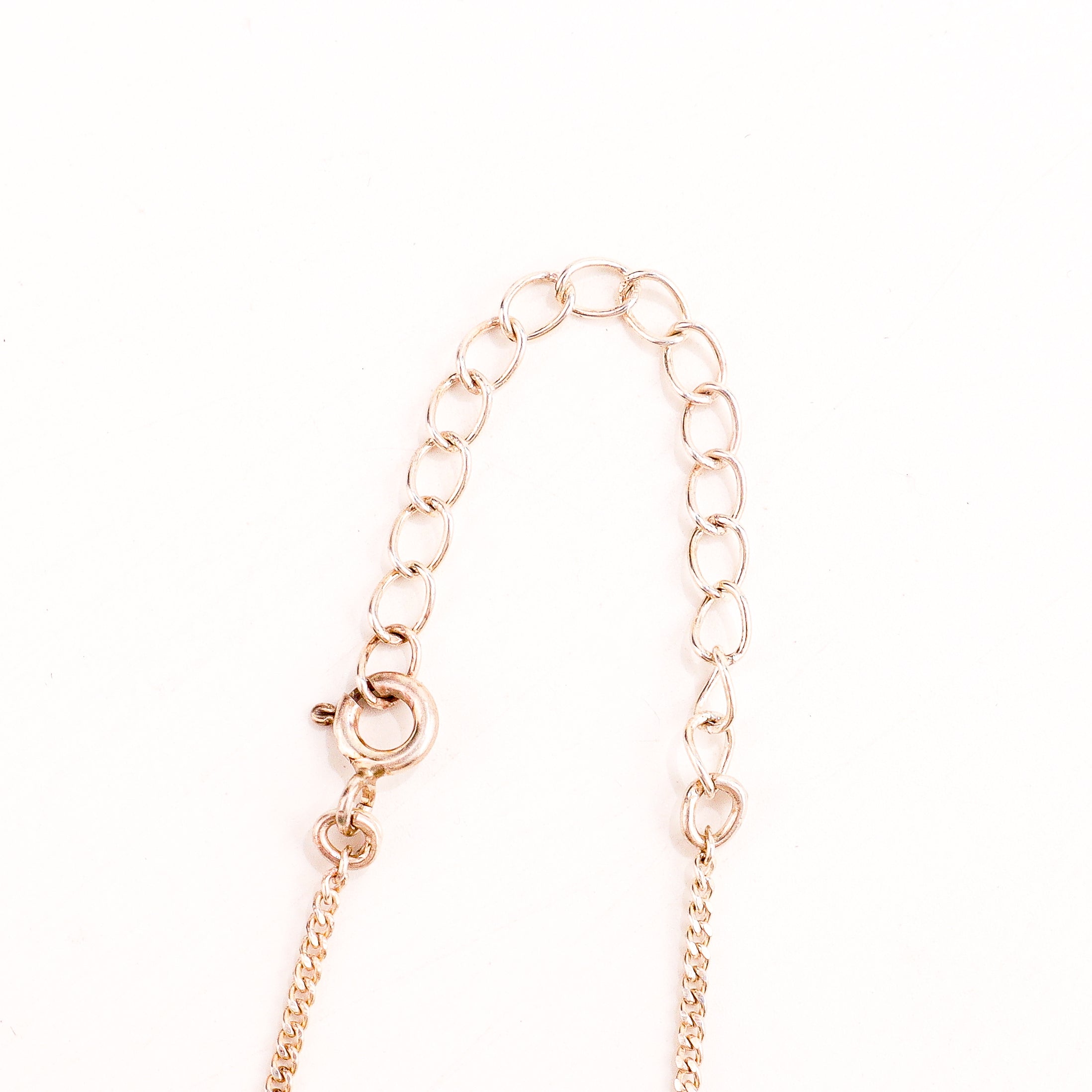 Spiral triangle silver necklace styled with contemporary outfit