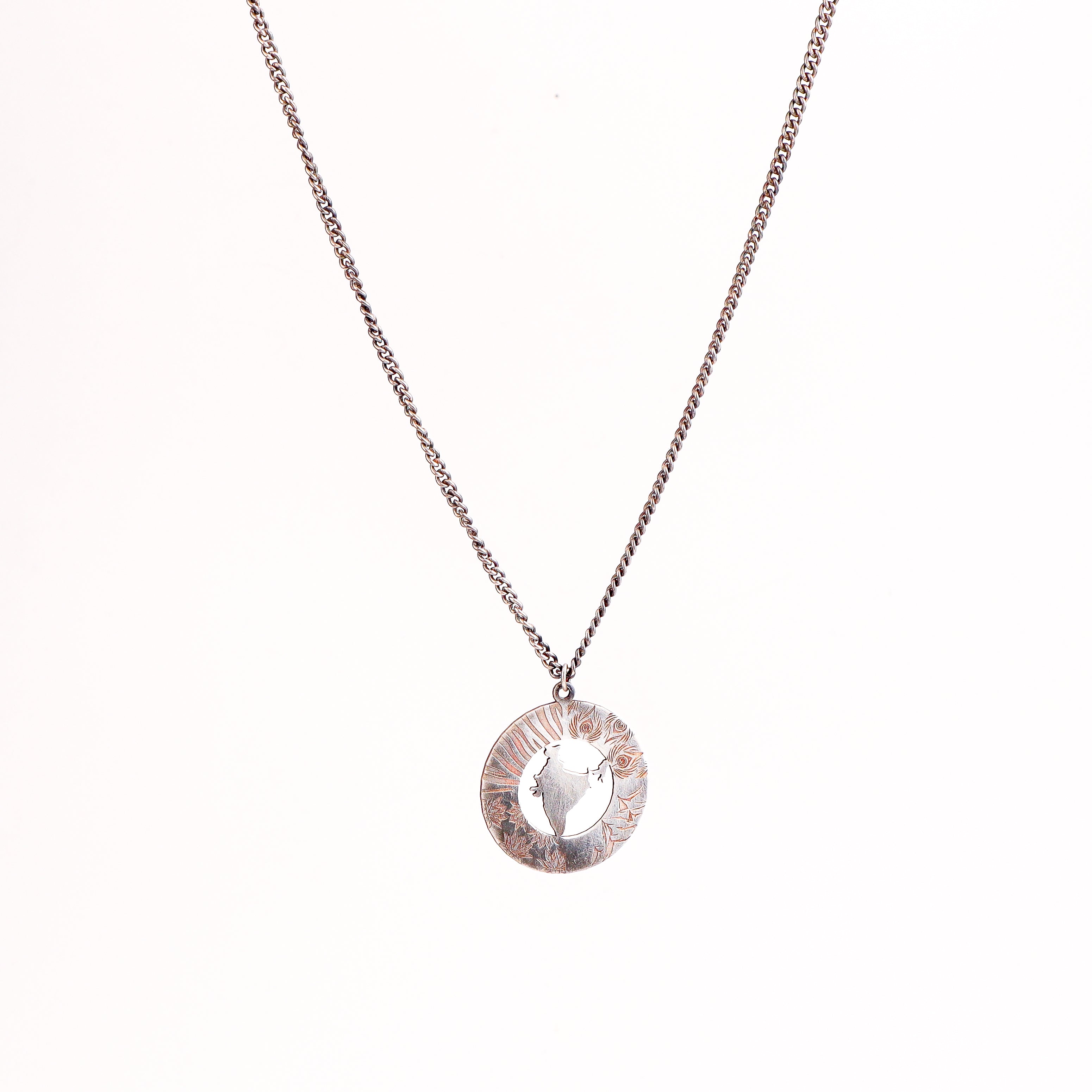 Flat-lay unisex India silver necklace on neutral background