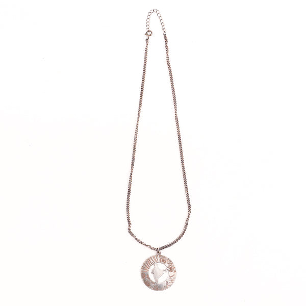 Detail shot highlighting polished silver finish of India pendant