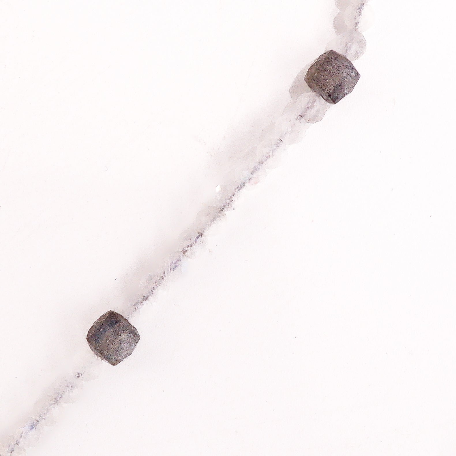 Silver trapezoid pendant necklace with moonstone on white background