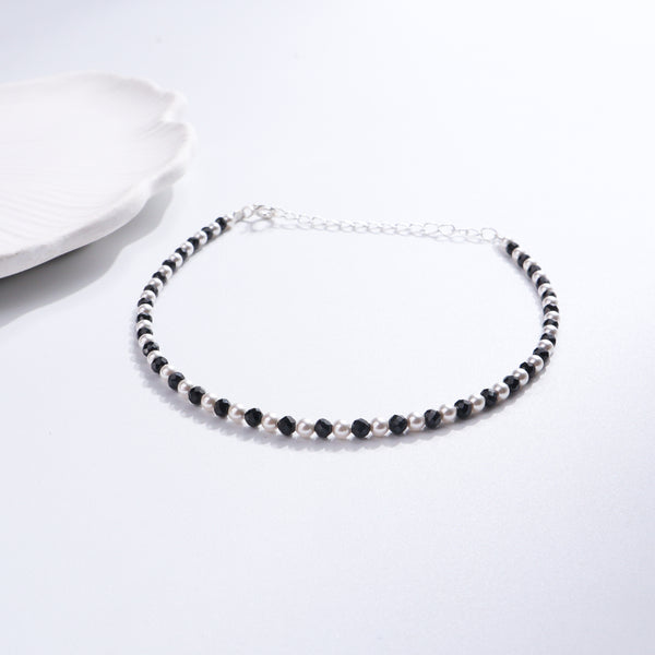 Black and white pearl and spinel anklet on white background