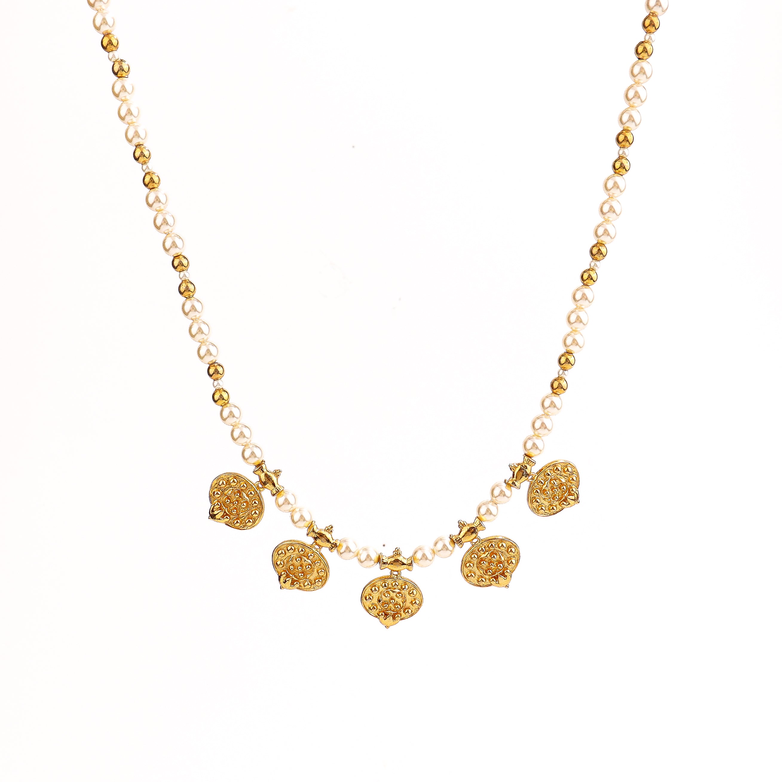 Flat-lay taait saaj motif necklace on neutral background