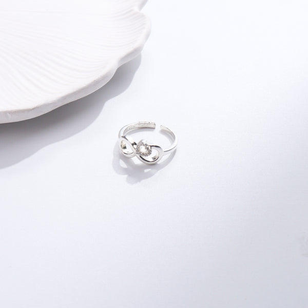 Silver CZ infinity heart ring on white background