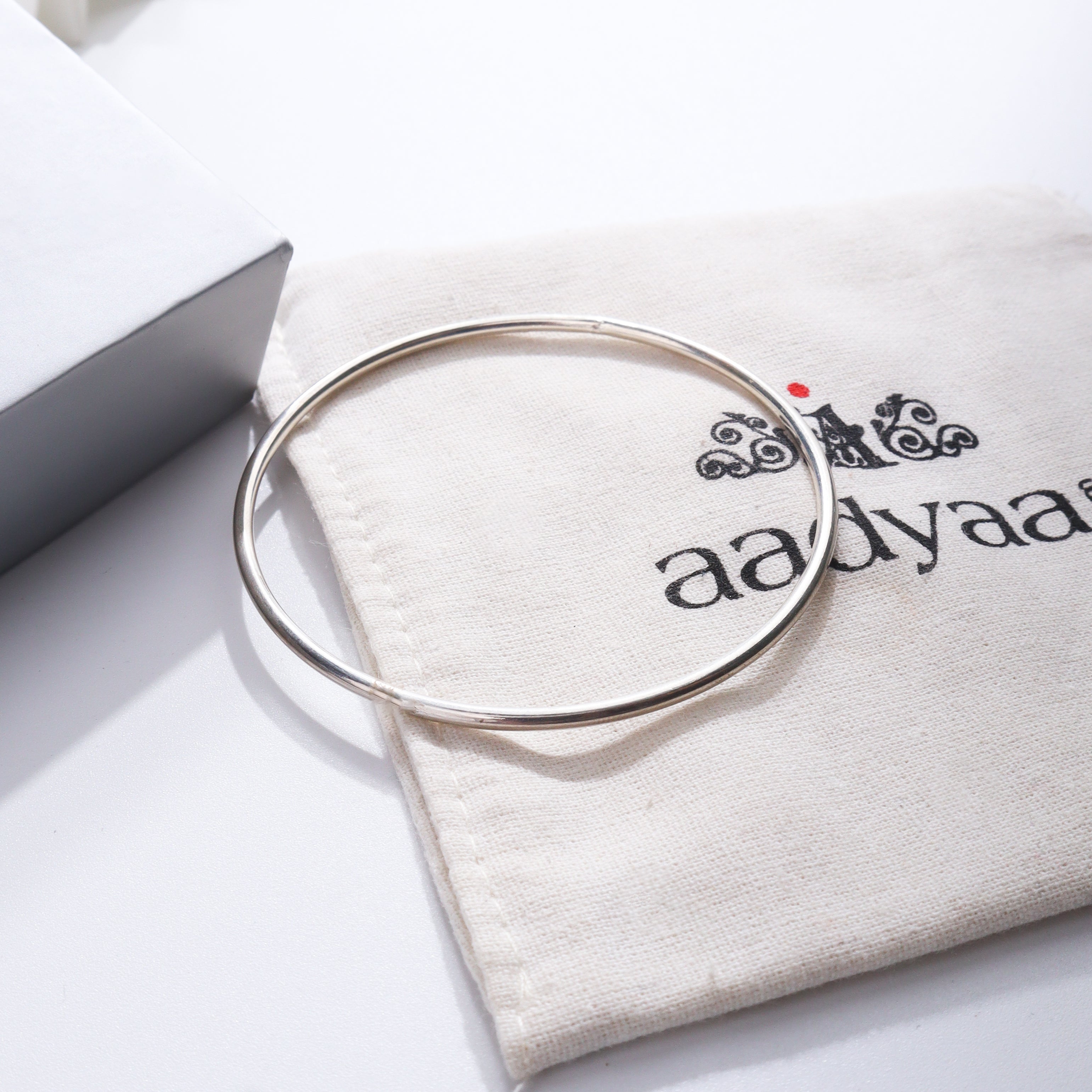 Plain Silver Bangle on Aadyaa jewelry pouch