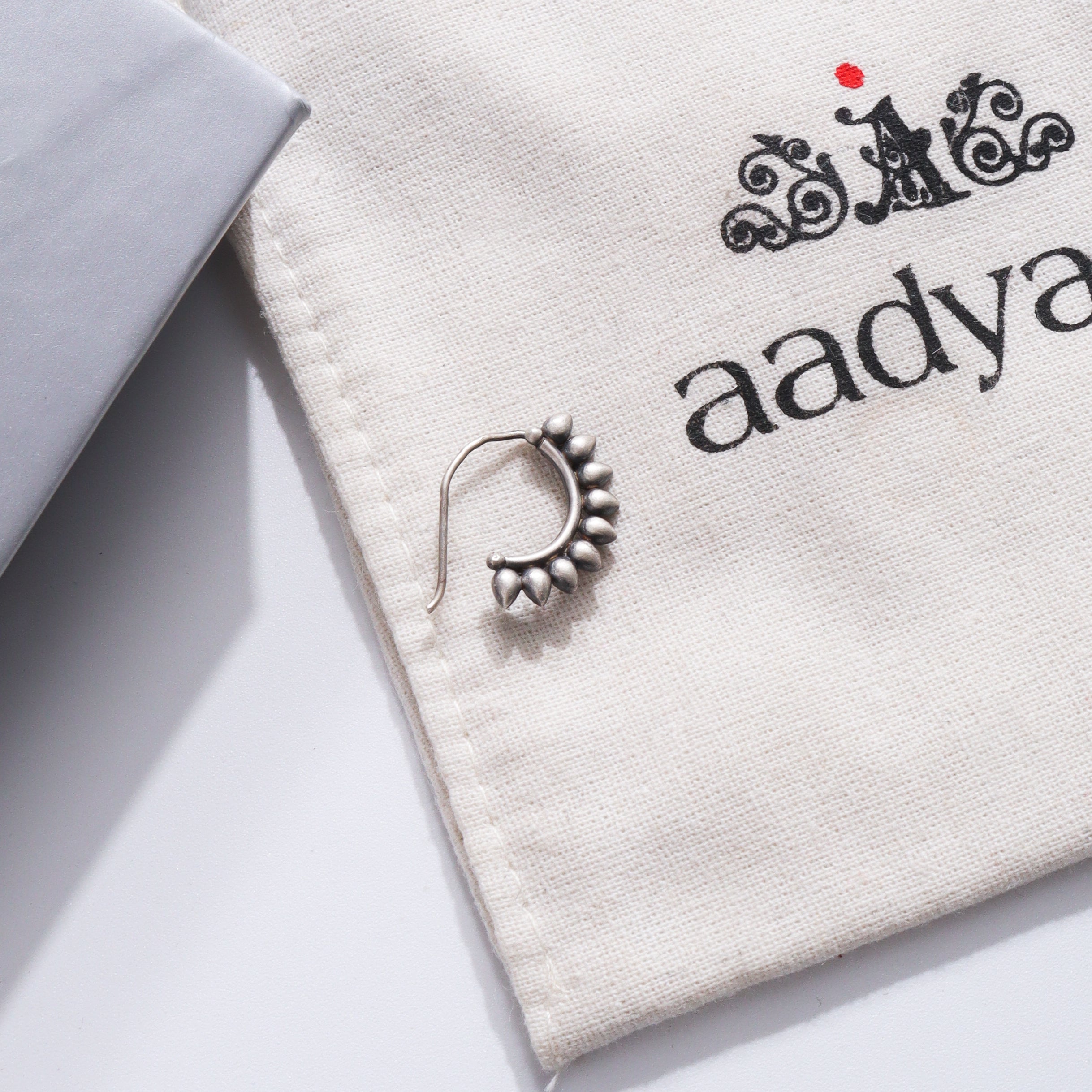 Petals Nath Left Pierced silver nose ring on Aadyaa fabric
