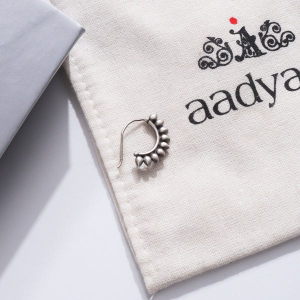 Petals Nath Left Pierced silver nose ring on Aadyaa fabric